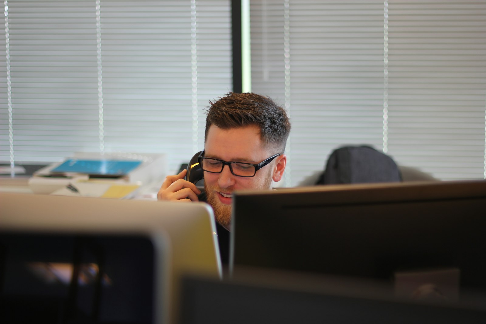 Engineers analyzing secure infrastructure on large monitors inside a federal operations center